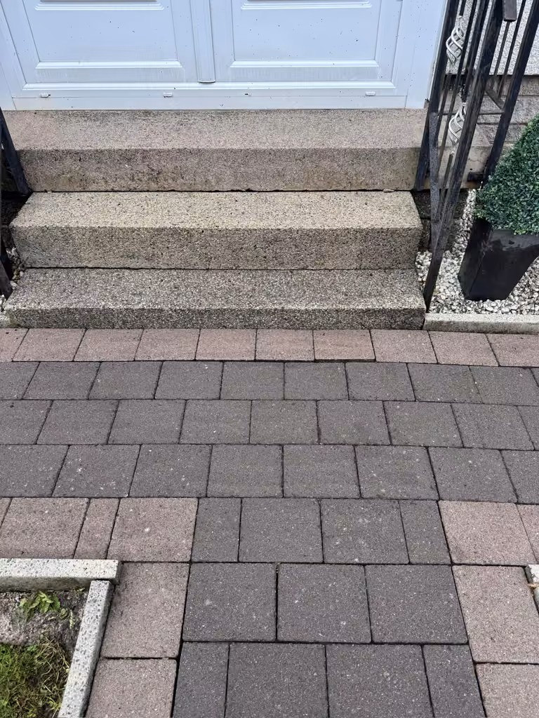 Clean paved path after pressure washing